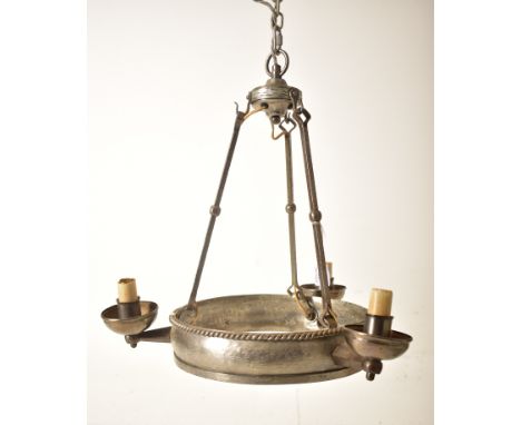 A 20th century Gothic style wrought iron hanging chandelier. The chandelier having a central halo section with three protrudi