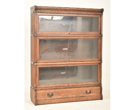 Globe Wernicke - An early 20th century oak three section stacking lawyer's bookcase. The bookcase having a pediment atop over