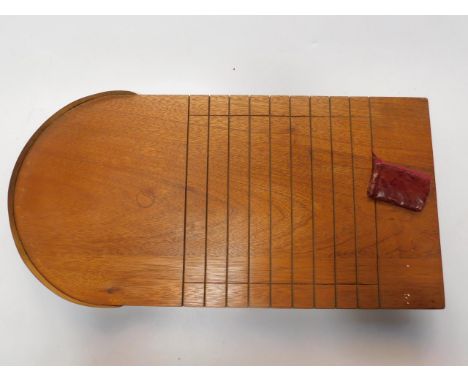 A mahogany and brass shove hapenny board, with various coins, together with the rules of the game.