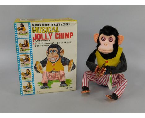 A Daishin battery operating musical Jolly Chimp, plays cymbals, glares, showing his teeth and chattering, No 7061, boxed.