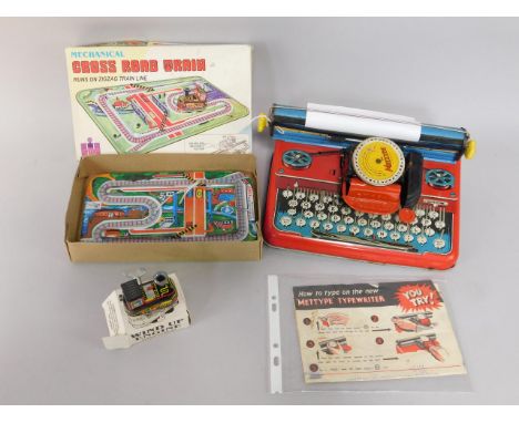 A Mettype Junior tinplate typewriter, with instruction leaflet, together with a Welby Mechanical Crossroad Train, boxed, (2).