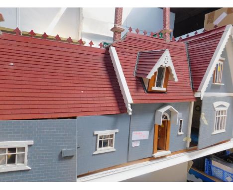 A large scratch built collector's dolls house, 1:12 scale red painted with roof grey simulated bricks and windows with wooden