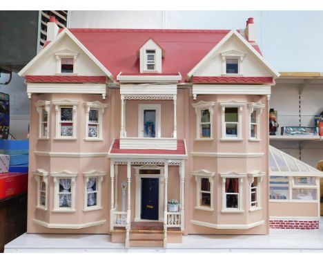 A large coral and cream painted collector's dolls house, 1:12 scale, with bay windows, Georgian style door and stained glass 