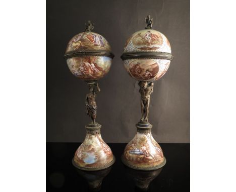 A near pair of 19th Century Viennese enamelled and gilt silver figural pedestal globes. One a hinged globe with timepiece to 