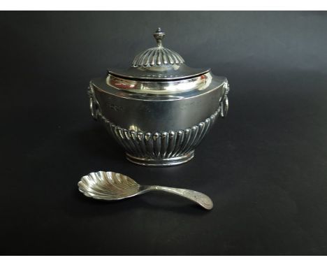 An Edwardian silver tea caddy of squat urn form, fluted lid and base, lion mask handles, London 1904, maker indistinct and li