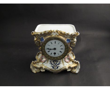 A Paul Mancel Paris mantel clock with gilt ceramic case, japy movement, pendulum and key (face crazed)