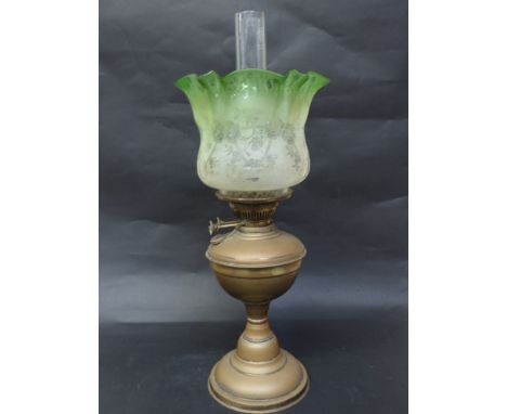 An Edwardian oil lamp with green tinted floral shade 
