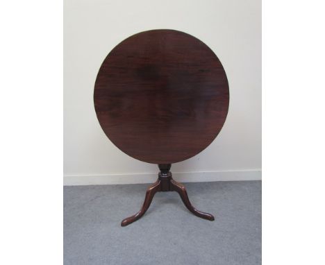 A circa 1760 mahogany wine table the circular tilt top on turned column and tripod base