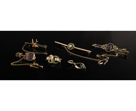 Three Victorian gold bar brooches including amethyst and pearl, opal and bird motif, a garnet set brooch, a sapphire pendant 