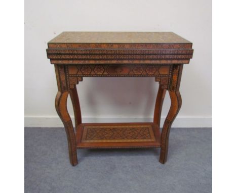 A 20th Moorish games table with parqueting detail, pull out card surface, fold over top, 62cm long