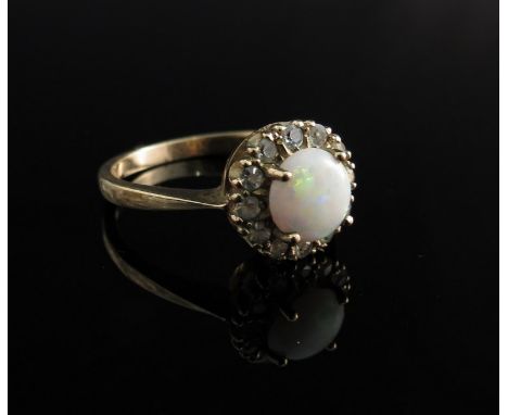 A 9ct gold opal and white stone ring