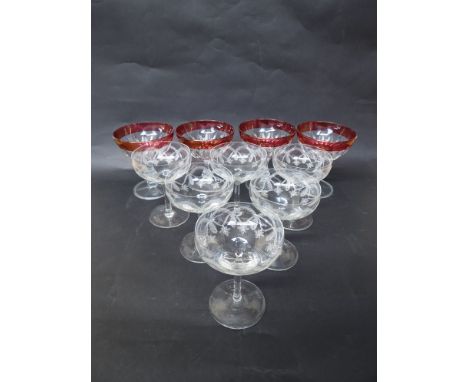 A set of six Edwardian etched glass champagne saucers, foliate swags and four further cranberry rimmed examples (10) 