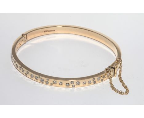 9ct yellow gold ladies hinged bangle, pave set with 2.25 carats of brilliant cut diamonds in a modern random pattern, safety 