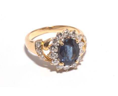 18ct yellow gold sapphire and diamond cluster ring, set with a large oval sapphire of good colour with diamond surround and s