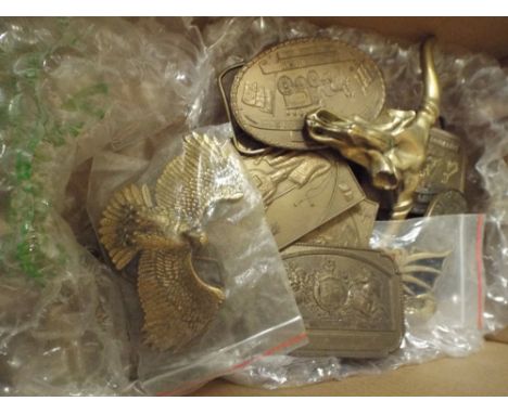 Box of brass American style and other belt buckles, enamel badges etc