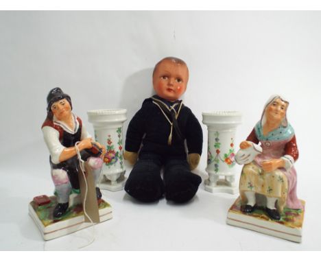 Pair of Staffordshire seated pottery figures of an elderly lady and gentleman; each approx 17 cm  high. Pair of small decorat