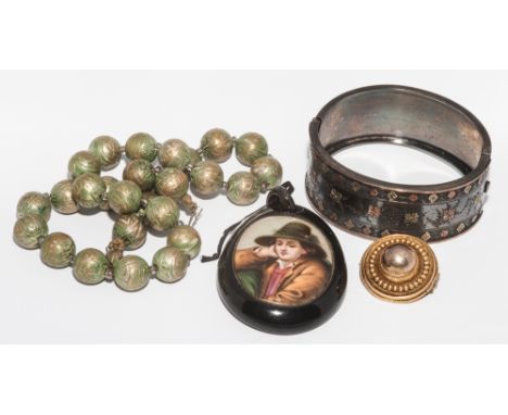 Victorian hinged bangle with silver and gold inlaid decoration, target brooch, oval locket pendant inset with porcelain panel