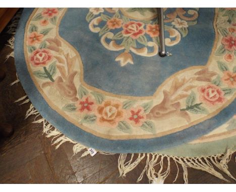 Circular green patterned Chinese rug and an oval blue patterned rug