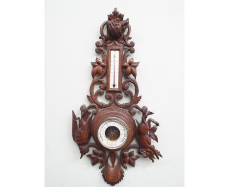 Black Forest wall barometer with thermometer in carved wooden case with dogs head and dead game