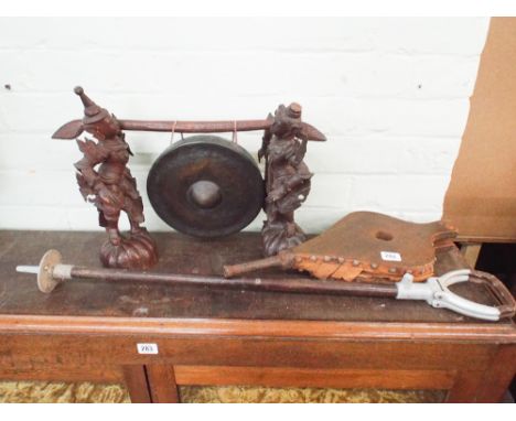 Burmese gong on figured stand, shooting stick and a pair of bellows