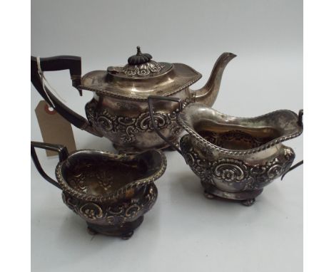 Walker and Hall Sheffield silver 3 piece tea service with embossed flower leaf and sea scroll decoration on ball feet.  Sheff