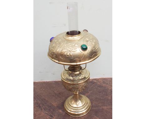Victorian brass oil lamp with embossed decoration, shade set with 3 coloured stones
