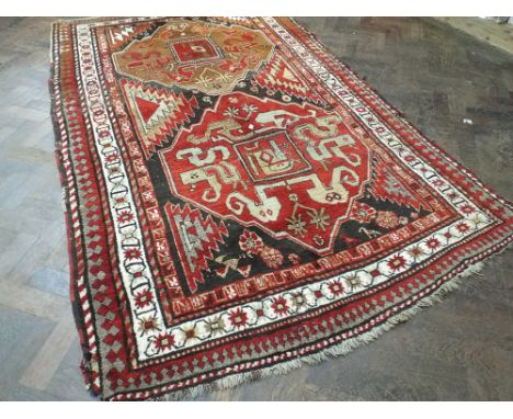 Red and patterned Kazak rug (7' 6" x 4' 8")