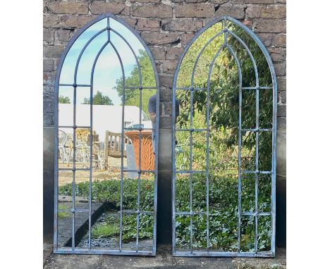 ARCHITECTURAL GARDEN MIRRORS, 140cm high, 60cm wide, a pair, arched frames. (2) 
