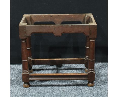 A 18th century oak table base, canon-barrel legs, bun feet, 63cm high, 70cm wide, 37cm deep, c.1720 