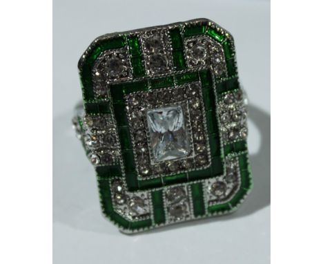 An Art Deco style base metal dress ring, green enamel and white glass stones, size M, boxed 