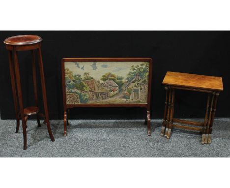 An early 20th century mahogany firescreen, c.1920; a mahogany nest of tables; an Edwardian mahogany plant stand, c.1905 (3) 