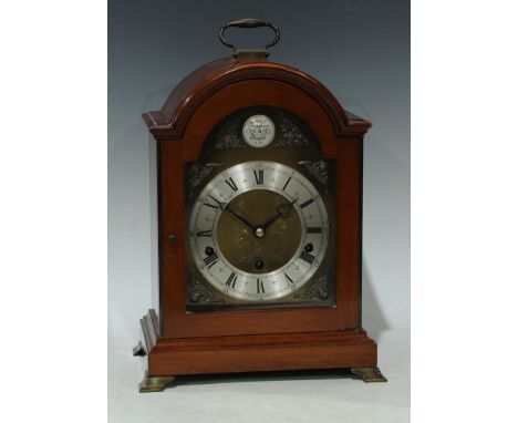 An Elliott mahogany bracket clock, 8-Day lever Westminster and Whittington chime, arched case, brass handle, silvered chapter