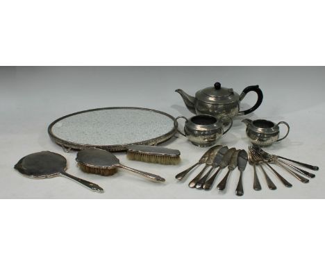 A silver three piece Art Deco hand mirror and hairbrush set, Birmingham 1941; a pewter three piece tea service; EPNS flatware