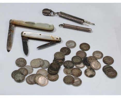 A silver and mother-of-pearl fruit knife; another steel and m-o-p; a quantity of silver thre'penny bits, 58g; a silver retrac