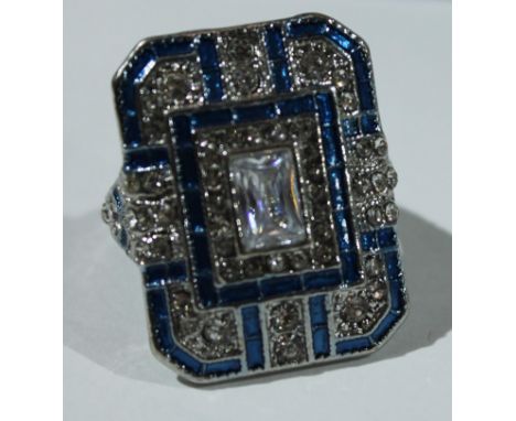 An Art Deco style base metal dress ring, blue enamel and white glass stones, size J, boxed 