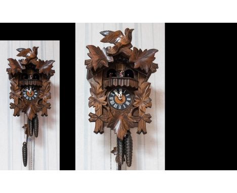 Black Forest - Good Quality Hand Carved Musical Walnut Cuckoo Clock. c.1950's. Decorated with Bird Figure and Leaves. Feature
