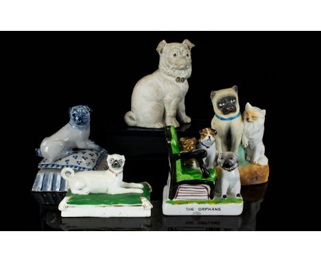 A Collection Of Ceramic Pug Dog Figurines Five in total, mostly late 19th/early 20th century to include a Fairing titled 'The