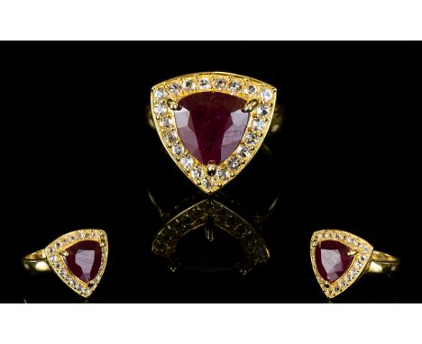 Ruby and White Topaz Trillion Shape Ring, a 6.5ct trillion cut ruby, framed with sparkling white topaz, bringing the total to