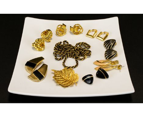 A Collection of 1980's Gold Tone Jewelry To include Napier enamel drop earrings, Napier hoop and knot earrings gold tone and 