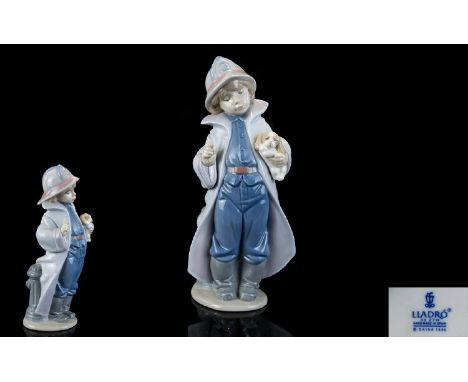 Lladro Porcelain Figure ' The Little Fireman ' Model Num 6334. Sculpture Juan Huerta. Issued 1997 - 2005. Height 8.75 Inches.