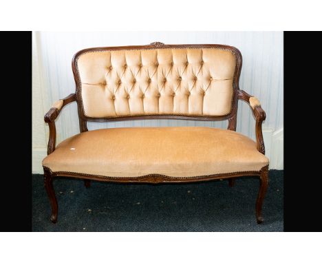 Antique Love Seat Mahogany frame with carved daisy detail to back rest carved apron and legs, the whole, upholstered in pale 