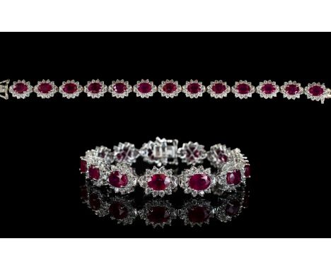 Ruby and Natural White Zircon Line Bracelet, 34cts of oval cut rubies framed with round cut natural white zircon, each rich r