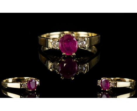 Ladies 9ct Gold Ruby and Diamond Dress Ring. The Central Ruby Flanked by Two Diamonds. All of Good Colour. Fully Hallmarked. 