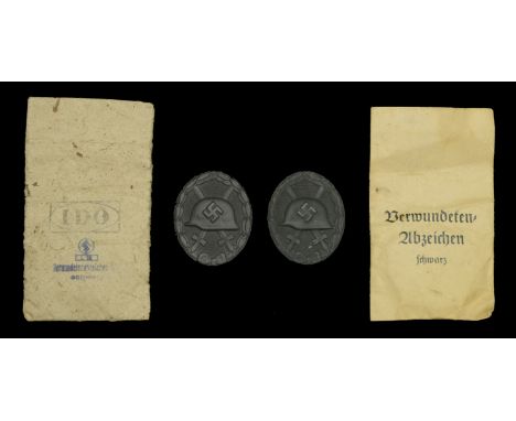 1939 Black Wound Badges in Presentation Packets. Two examples, the first by Fritz Kolm. Late War type with matt black finish 