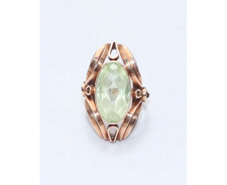 A 14ct gold ring set with an oval pale green coloured stone, with large carved surround, gross weight approx 7.7g