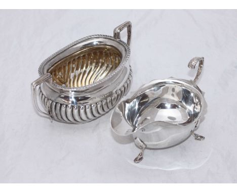 An early 20th century silver twin-handled sugar bowl with half-gadrooned body, Birmingham, 1913, together with a silver cream