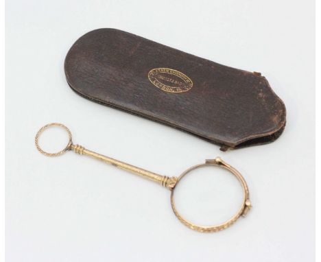 A 9ct gold folding lorgnette with scrolling and floral carved decoration, in leather slipcase embossed with company logo for 