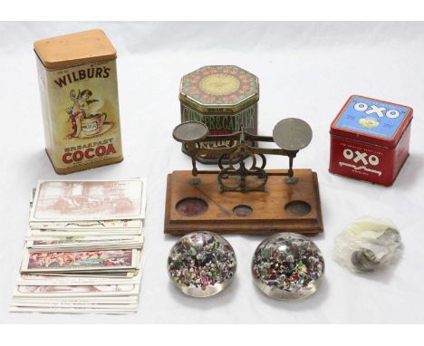 A quantity of assorted collectable items including a set of brass scales, two glass paperweights, three various vintage tins 