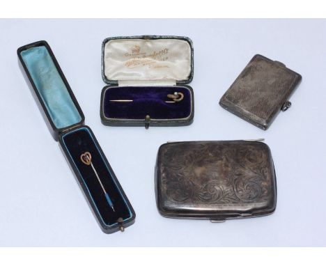 A silver cigarette case and a silver vesta case, together with two cased yellow metal stick pins. Gross weight of silver item