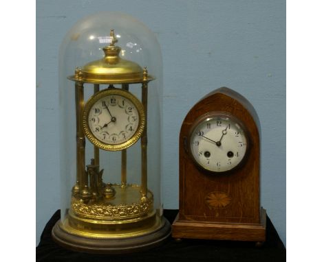 A laquered brass anniversary clock under glass dome, with Arabic numerals to the dial, 42cm high, (pendulum requires re-hangi